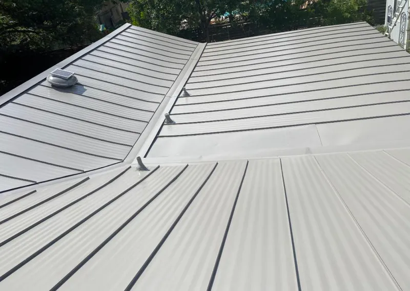 Solar attic fan installed on a metal roof for Roof Ventilation in Gainesville
